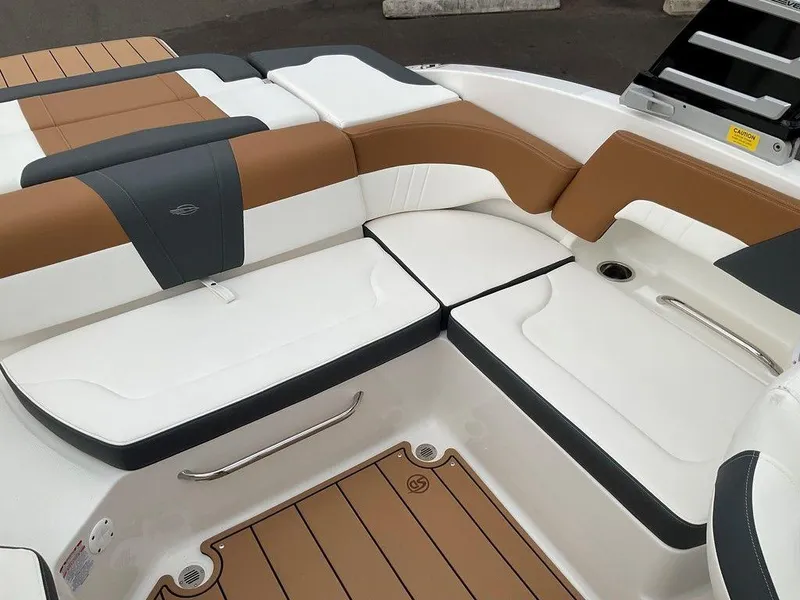 Slide: The Image of 2025 Chaparral 23 SSi boat interior with brown and white seating. - 14