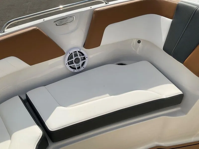 Slide: The Image of 2025 Chaparral 23 SSi boat interior with cushioned seating and speaker. - 15