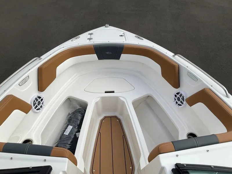 Slide: The Image of 2025 Chaparral 23 SSi boat interior with tan and white seating, modern design. - 18