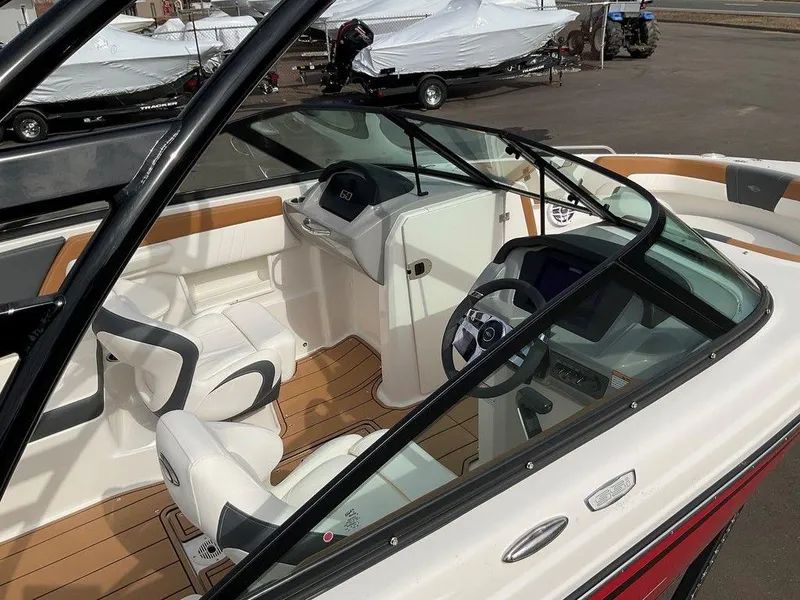 Slide: The Image of 2025 Chaparral 23 SSi boat interior with modern dashboard and seating. - 2