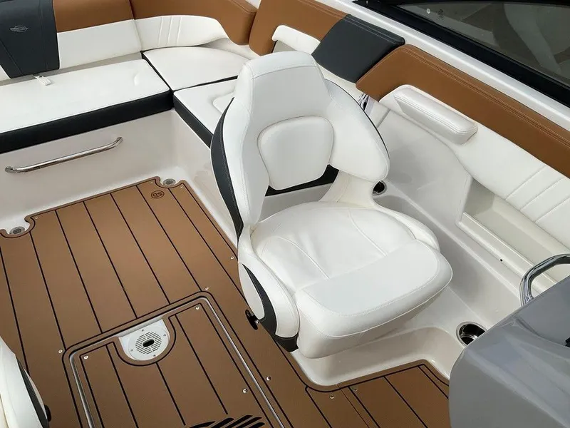Slide: The Image of 2025 Chaparral 23 SSi boat interior with white seating and brown flooring. - 21