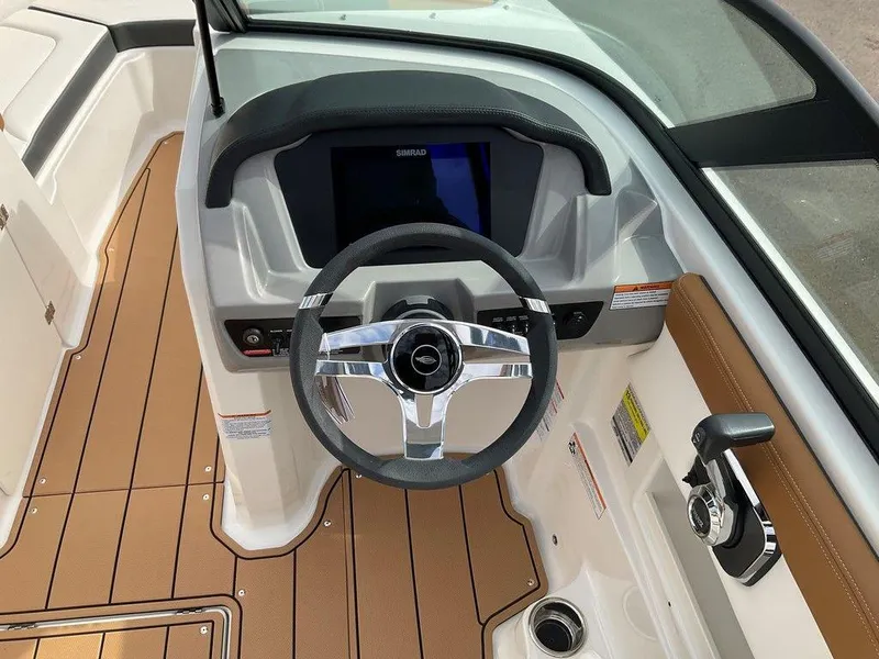 Slide: The Image of 2025 Chaparral 23 SSi boat dashboard with steering wheel and control panel. - 28