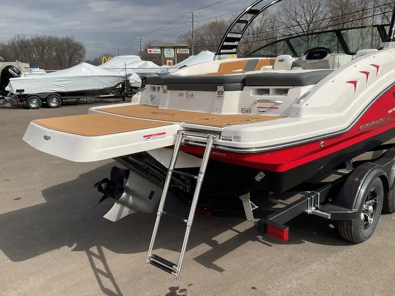 Slide: The Image of 2025 Chaparral 23 SSi boat with swim platform and ladder, parked on a trailer. - 3
