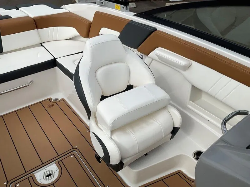 Slide: The Image of 2025 Chaparral 23 SSi boat interior with white and brown seating. - 31