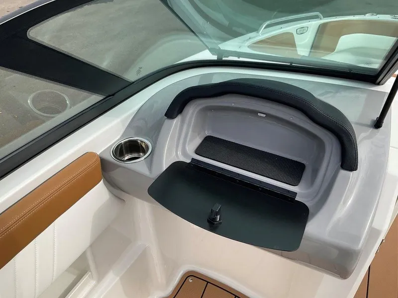 Slide: The Image of 2025 Chaparral 23 SSi boat interior with storage compartment and cup holder. - 36