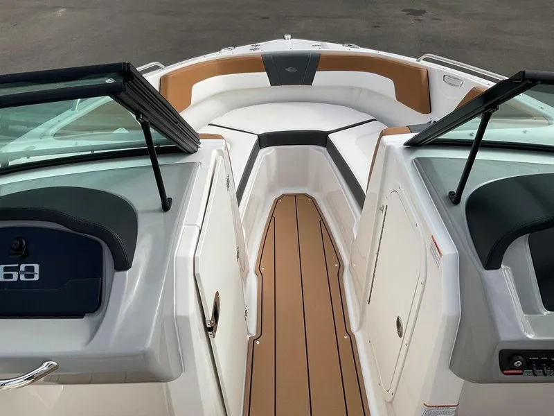 Slide: The Image of 2025 Chaparral 23 SSi boat interior with tan and white seating and sleek design. - 39