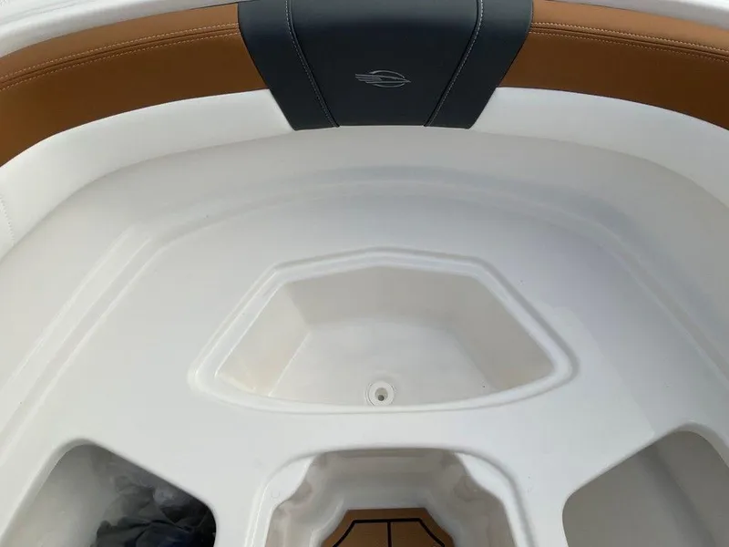 Slide: The Image of 2025 Chaparral 23 SSi boat interior with white and brown seating. - 42