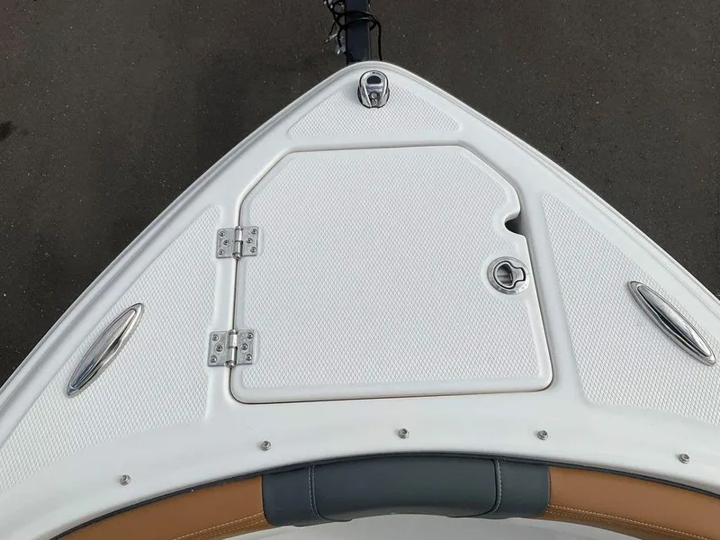 Slide: The Image of Bow of 2025 Chaparral 23 SSi boat with storage compartment and cleats. - 44