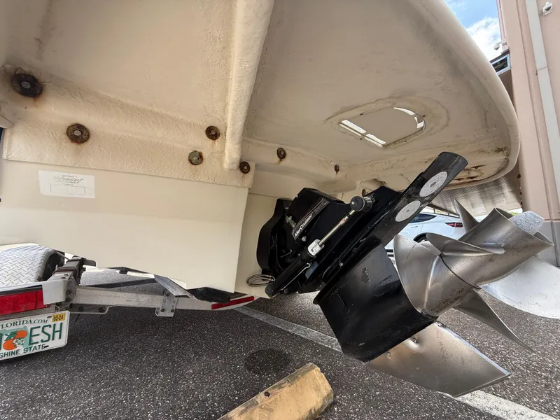 Slide: The Image of 2008 Sea Ray 210 Sundeck boat stern with propeller and trailer visible. - 20