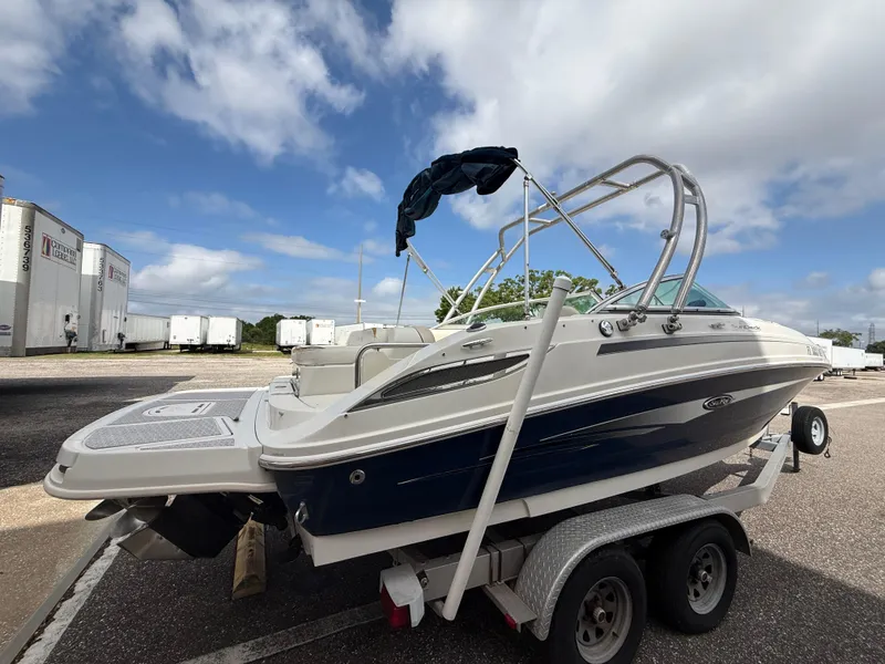 Slide: The Image of 2008 Sea Ray 210 Sundeck boat on trailer under cloudy sky. - 26