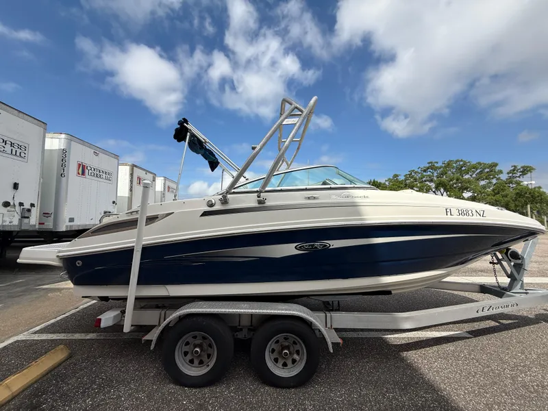 Slide: The Image of 2008 Sea Ray 210 Sundeck boat on trailer under blue sky. - 27