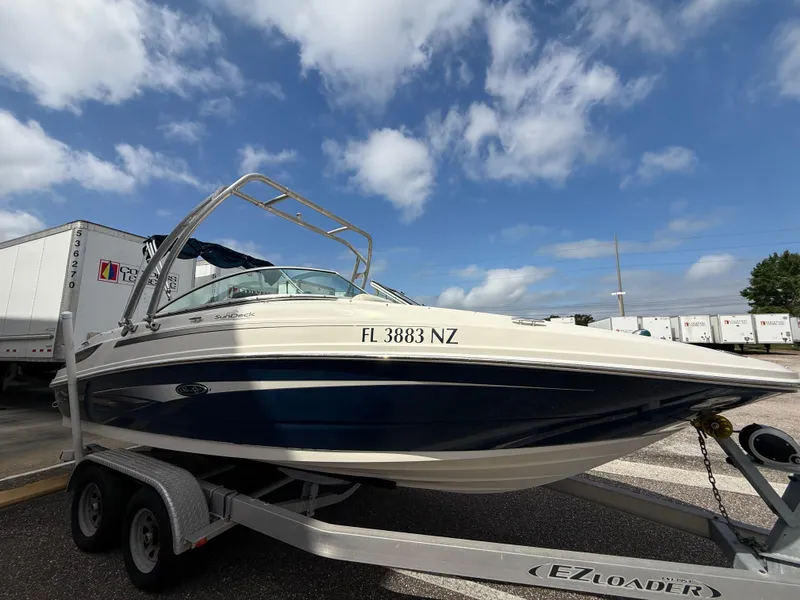 Slide: The Image of 2008 Sea Ray 210 Sundeck boat on trailer under blue sky. - 28