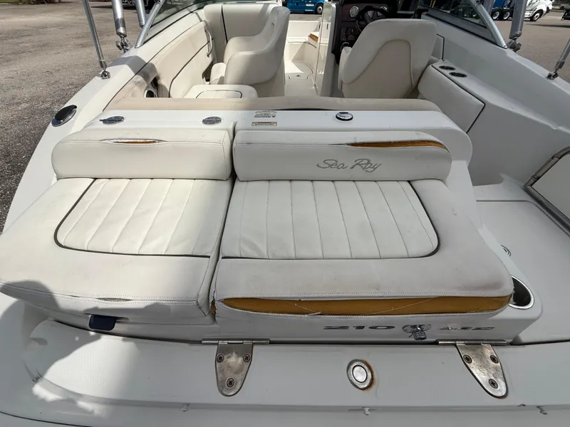 Slide: The Image of 2008 Sea Ray 210 Sundeck boat interior with white leather seating and sleek design. - 32
