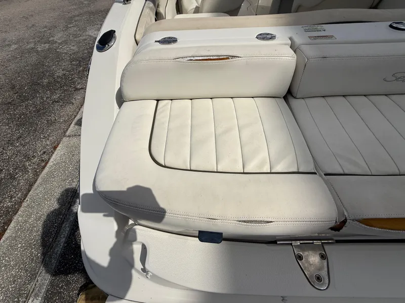 Slide: The Image of 2008 Sea Ray 210 Sundeck boat with white cushioned seating. - 33