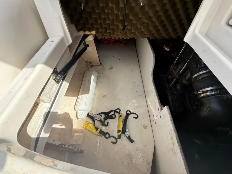 Slide: The Image of Interior view of a 2008 Sea Ray 210 Sundeck storage compartment with tools. - 34