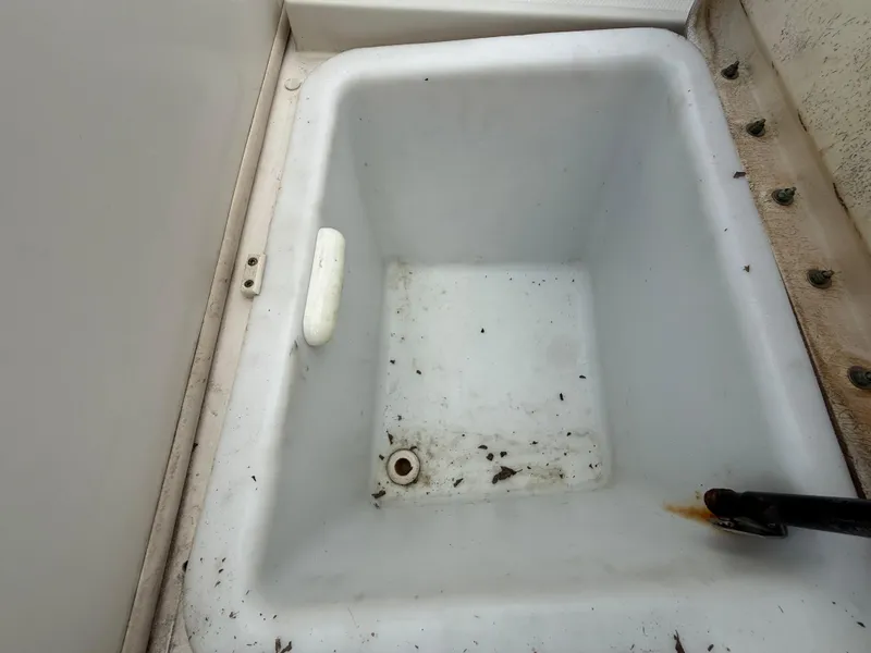 Slide: The Image of Storage compartment on a 2008 Sea Ray 210 Sundeck boat, showing some dirt and debris. - 36