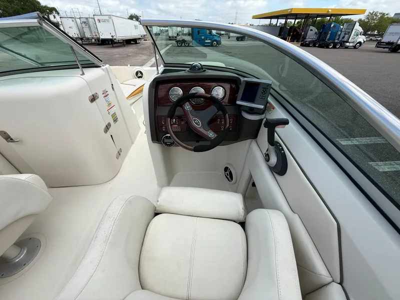 Slide: The Image of 2008 Sea Ray 210 Sundeck boat interior with steering wheel and dashboard controls. - 39