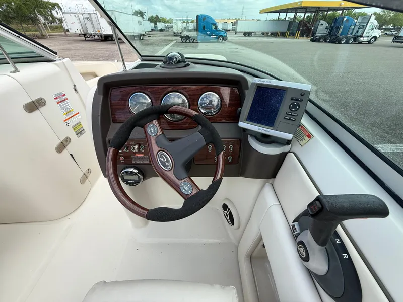 Slide: The Image of 2008 Sea Ray 210 Sundeck dashboard with steering wheel and navigation system. - 40