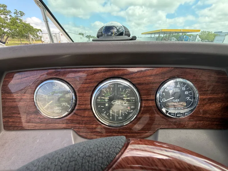 Slide: The Image of Dashboard of 2008 Sea Ray 210 Sundeck boat with wood finish and gauges. - 44