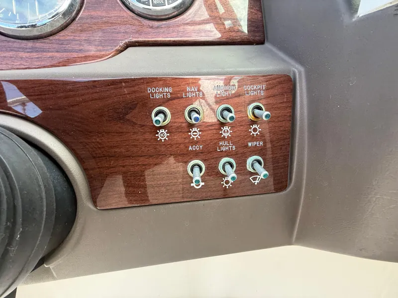Slide: The Image of Control panel of a 2008 Sea Ray 210 Sundeck boat with various switches. - 46