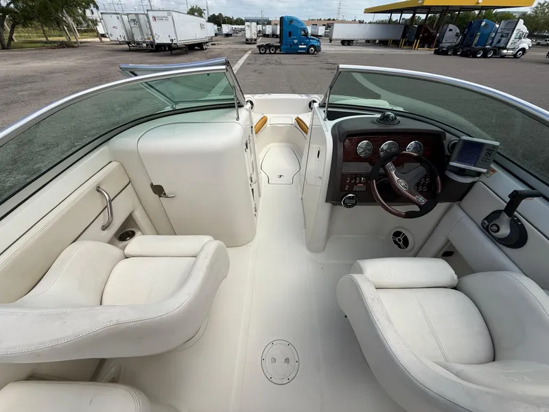 Slide: The Image of 2008 Sea Ray 210 Sundeck interior with white seating and dashboard view. - 47