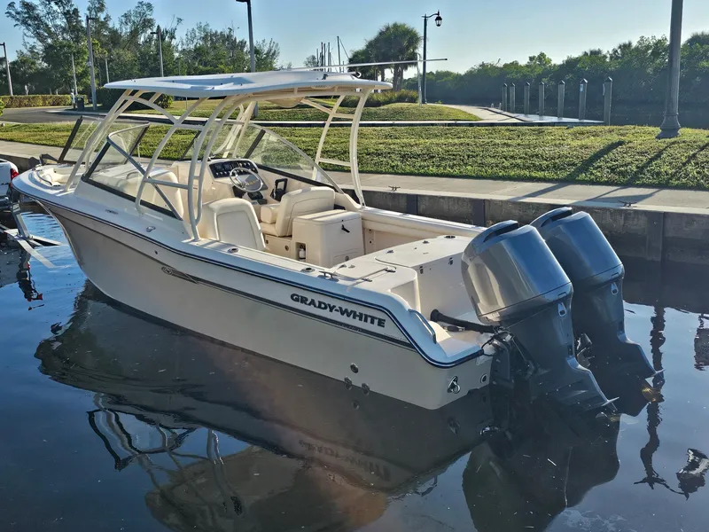 Slide: The Image of 2015 Grady-White Freedom 275 boat docked with dual engines, sunny day. - 0