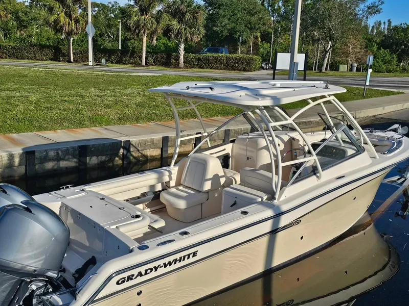 Slide: The Image of 2015 Grady-White Freedom 275 boat docked, featuring sleek design and spacious seating. - 1