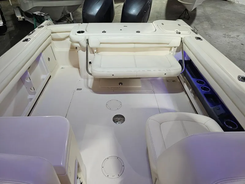 Slide: The Image of 2015 Grady-White Freedom 275 boat interior with seating and cup holders. - 11