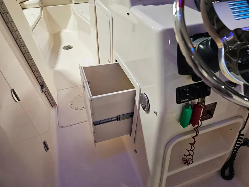 Slide: The Image of 2015 Grady-White Freedom 275 boat interior with open storage compartment. - 12