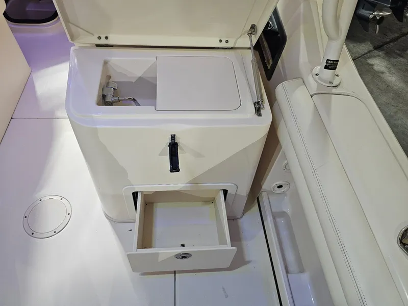 Slide: The Image of 2015 Grady-White Freedom 275 boat interior with storage compartment and seating. - 14