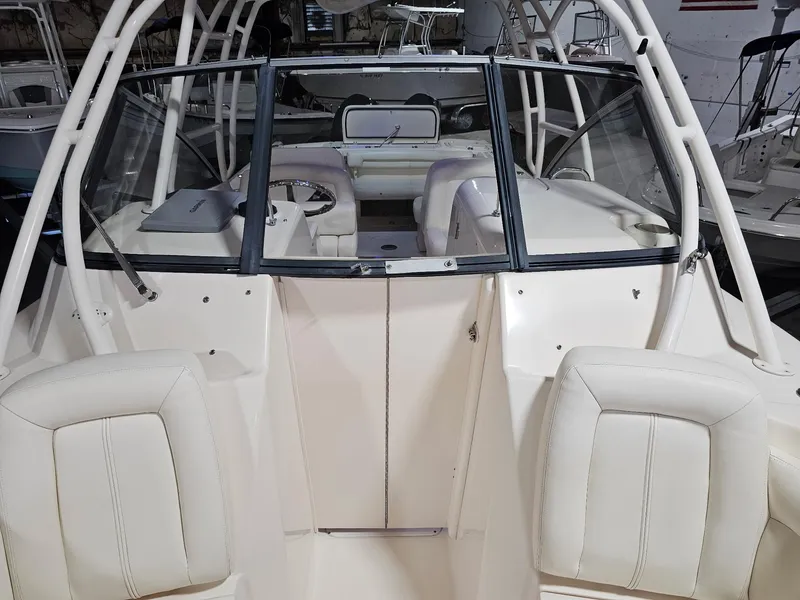 Slide: The Image of 2015 Grady-White Freedom 275 boat interior with white seating and helm. - 15