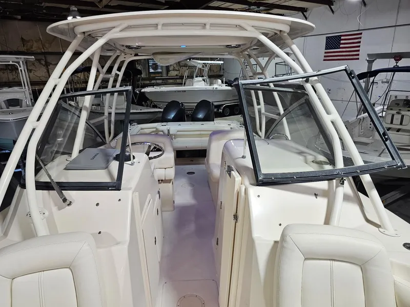 Slide: The Image of 2015 Grady-White Freedom 275 boat interior with open windshield and seating. - 16