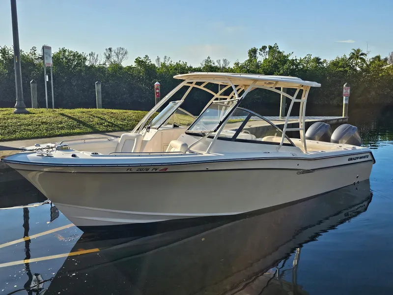 Slide: The Image of 2015 Grady-White Freedom 275 boat docked in calm waters, sunny day. - 3