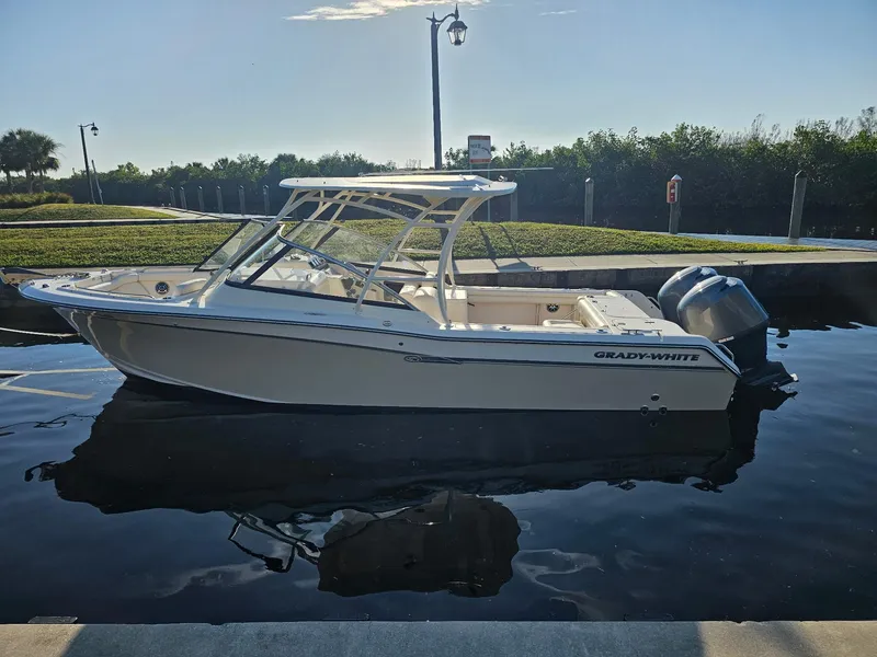 Slide: The Image of 2015 Grady-White Freedom 275 boat docked on calm water. - 4