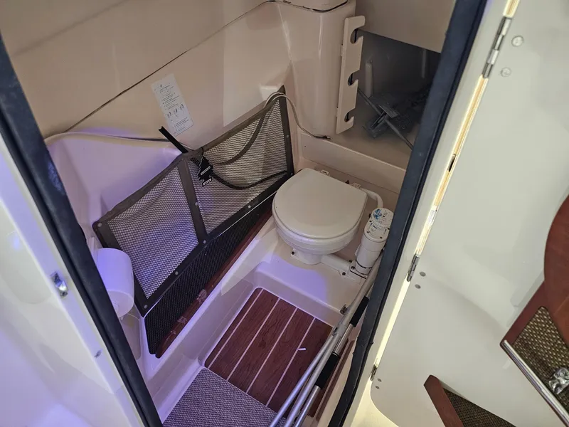 Slide: The Image of 2015 Grady-White Freedom 275 boat interior with compact bathroom amenities. - 5