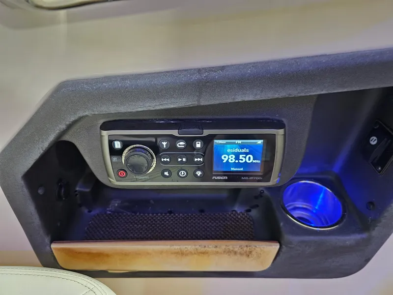 Slide: The Image of Control panel of 2015 Grady-White Freedom 275 boat with radio and cup holder. - 8