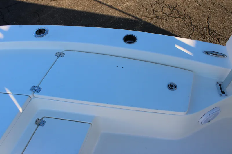 Slide: The Image of 2025 Avenger AV26 boat deck with storage compartments and rod holders. - 10