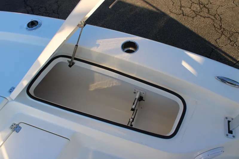 Slide: The Image of Open storage compartment on 2025 Avenger AV26 boat deck. - 14