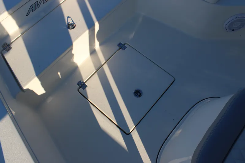Slide: The Image of Avenger AV26 2025 boat deck with storage hatch and shadows. - 16