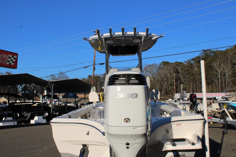 Slide: The Image of 2025 Avenger AV26 boat with 300 horsepower engine, parked outdoors. - 2