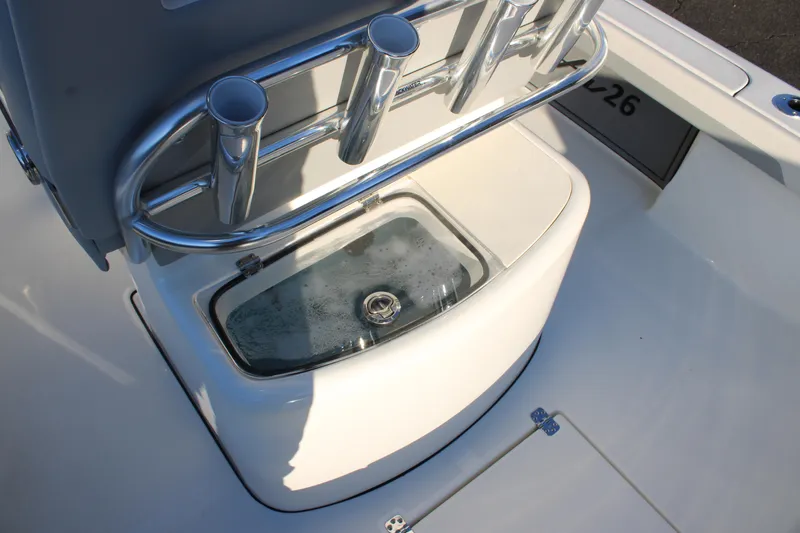 Slide: The Image of 2025 Avenger AV26 boat interior with rod holders and livewell. - 21