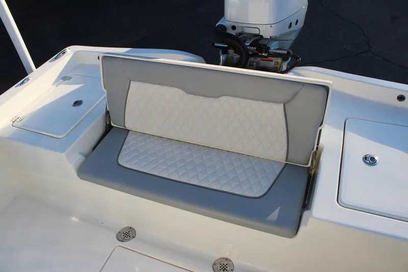 Slide: The Image of 2025 Avenger AV26 boat with cushioned seating and motor detail. - 25