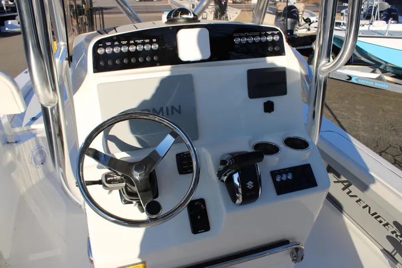 Slide: The Image of Avenger AV26 2025 boat dashboard with steering wheel and controls. - 3