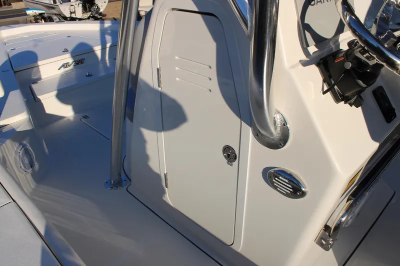 Slide: The Image of 2025 Avenger AV26 boat console with steering wheel and storage compartment. - 8