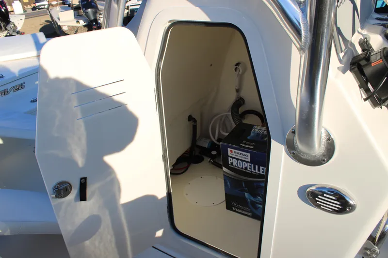 Slide: The Image of Open storage compartment on Avenger AV26 boat, showing propeller box inside. - 9