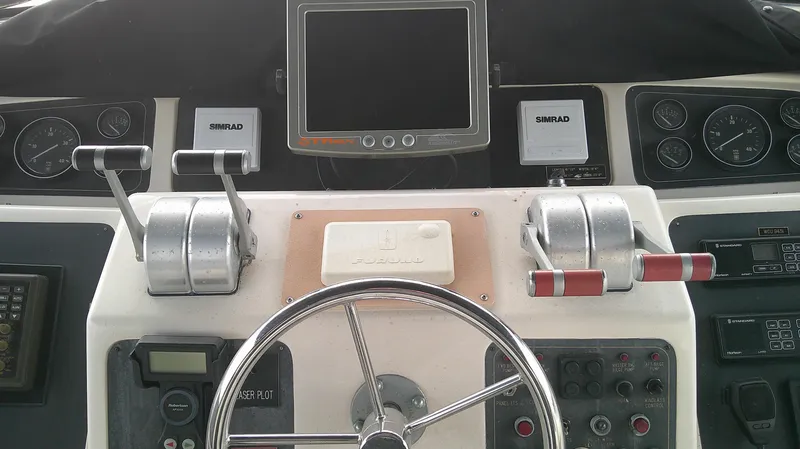 Slide: The Image of Control panel of a 1996 Ocean Alexander 546 Yachtfisher with steering wheel and navigation instruments. - 10