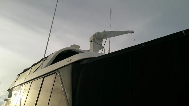 Slide: The Image of 1996 Ocean Alexander 546 Yachtfisher, partial view with crane, under cloudy sky. - 22