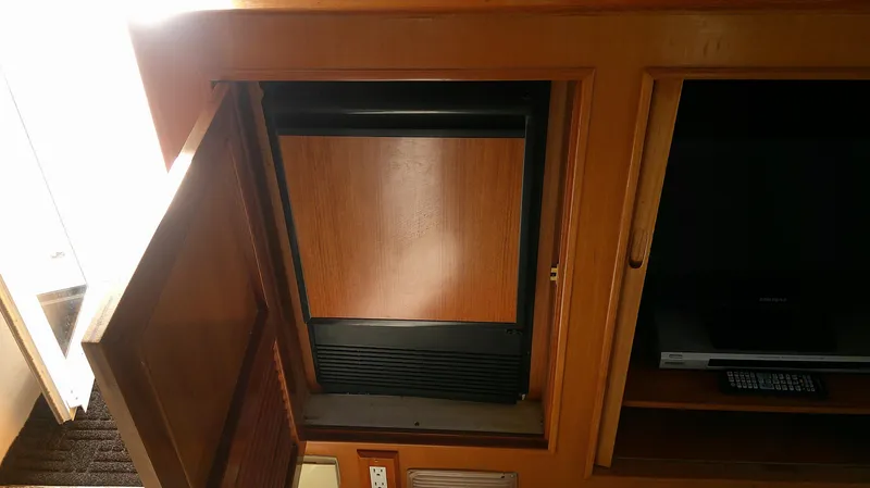 Slide: The Image of 1996 Ocean Alexander 546 Yachtfisher interior with wooden cabinetry and built-in appliances. - 27