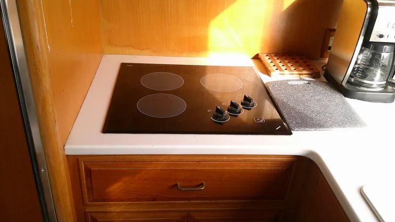 Slide: The Image of 1996 Ocean Alexander 546 Yachtfisher kitchen with stovetop and coffee maker. - 32