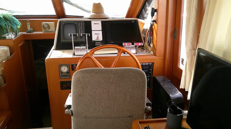 Slide: The Image of 1996 Ocean Alexander 546 Yachtfisher helm with wooden wheel and navigation equipment. - 37